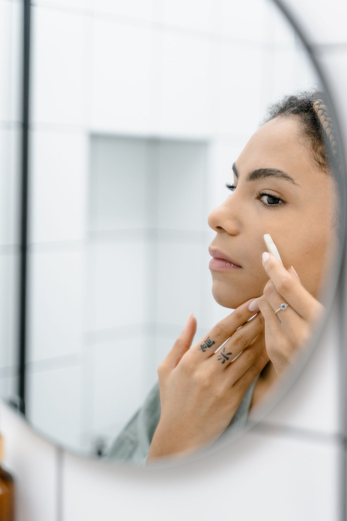 Woman looking at her skin in a mirror